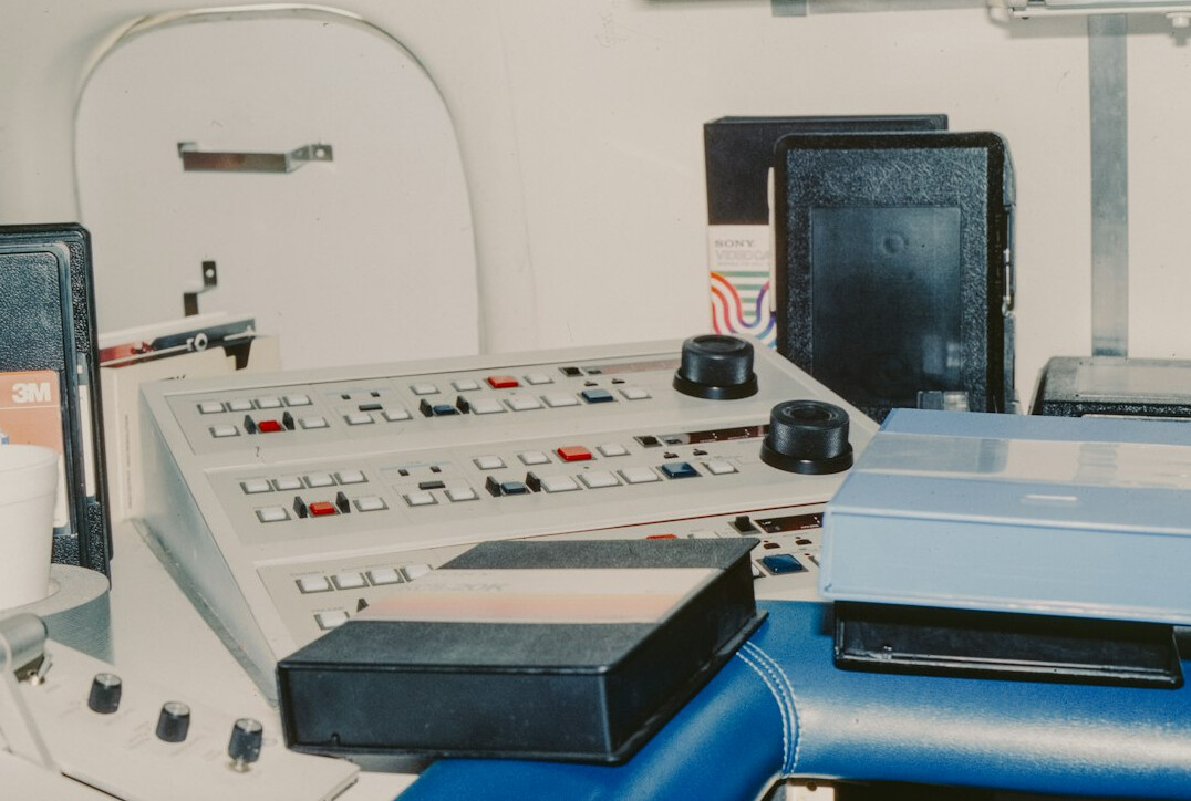 Broadcast vision mixer with illuminated buttons in a control room
