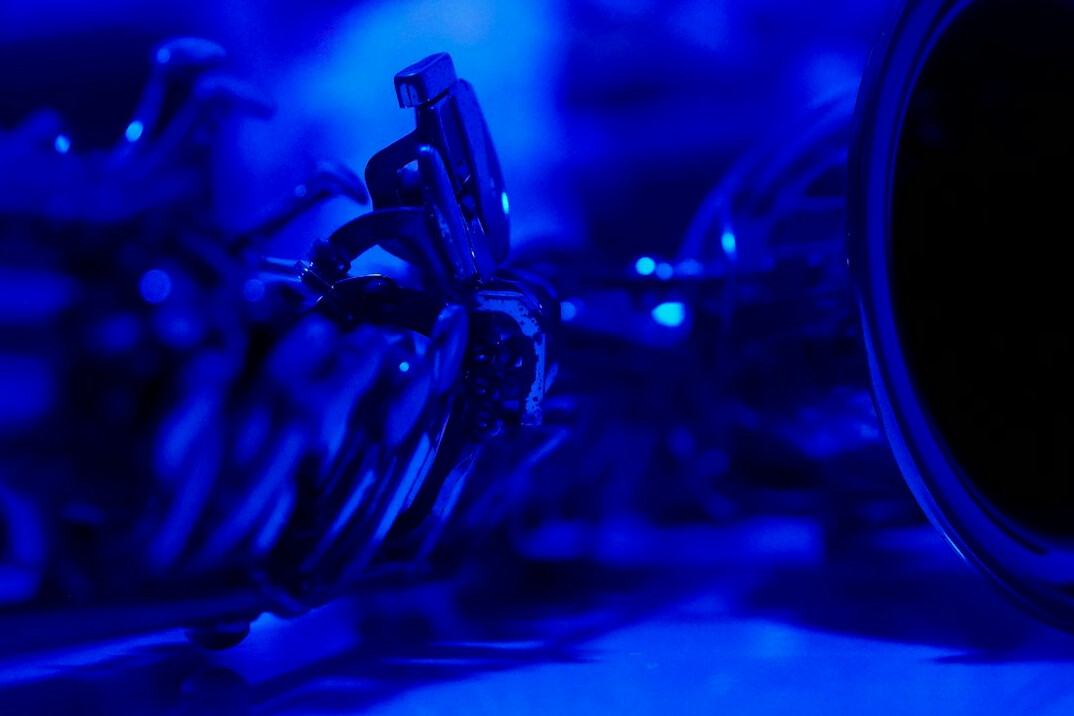 Broadcast camera pointed at a lit television studio set