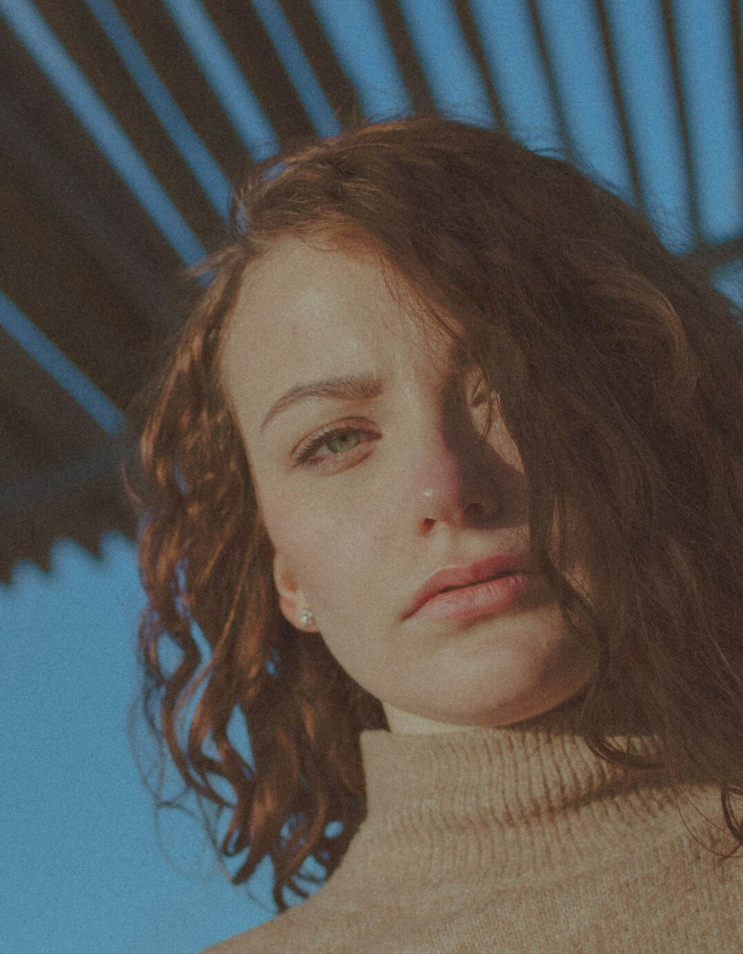 Portrait of a woman with curly brown hair